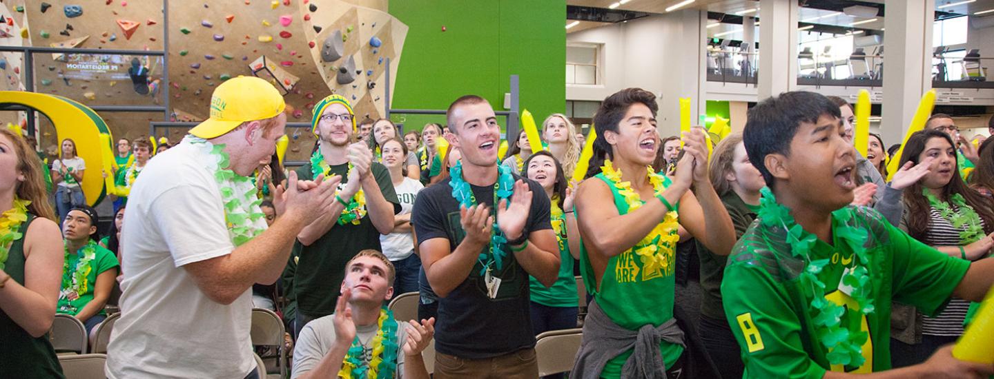 Get involved in life on campus. Students yell with excitement during a Ducks watch party in the Student Recreation Center.